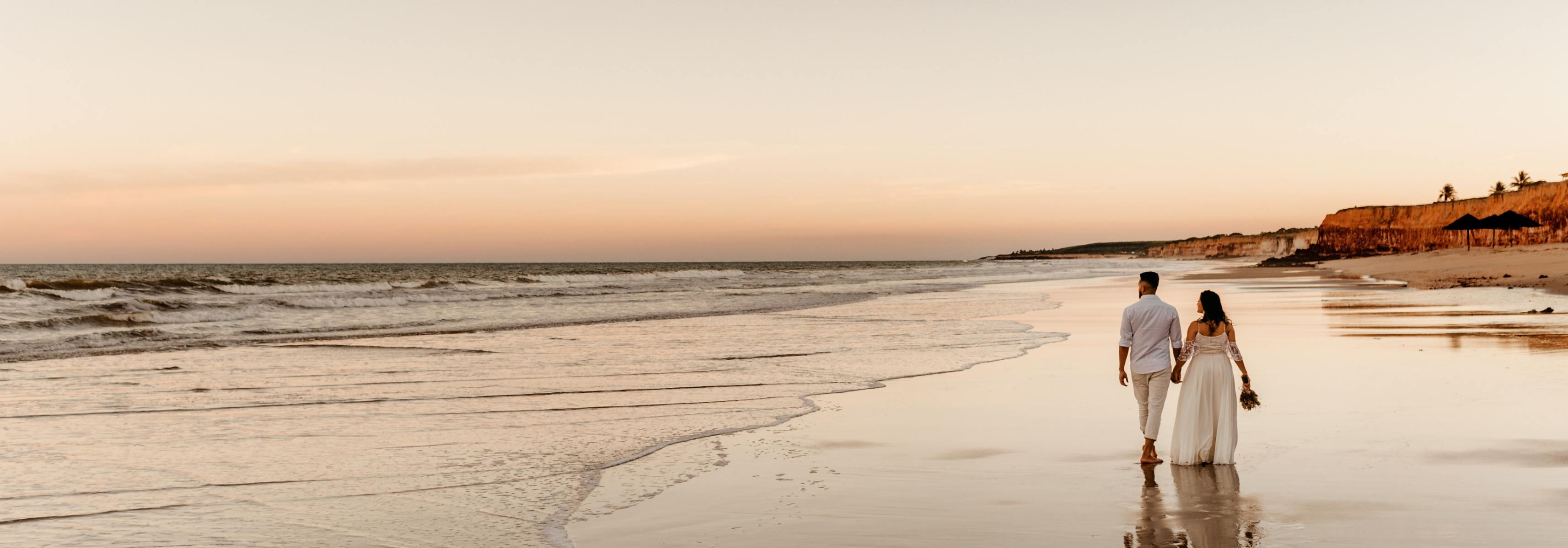 Married couple walking on a beach