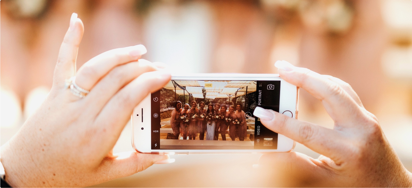 Someone taking a photo of a wedding on their smartphone