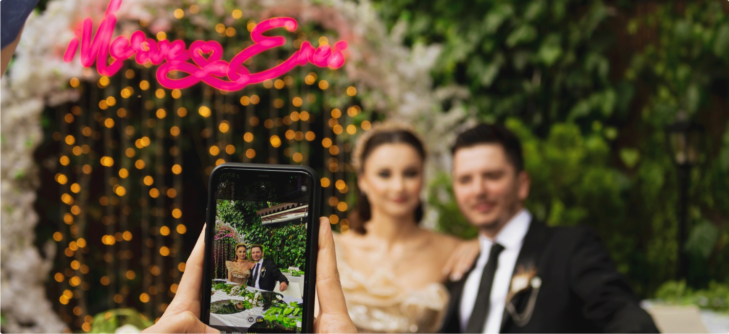 A photo of a couple at a wedding being taken on a smartphone