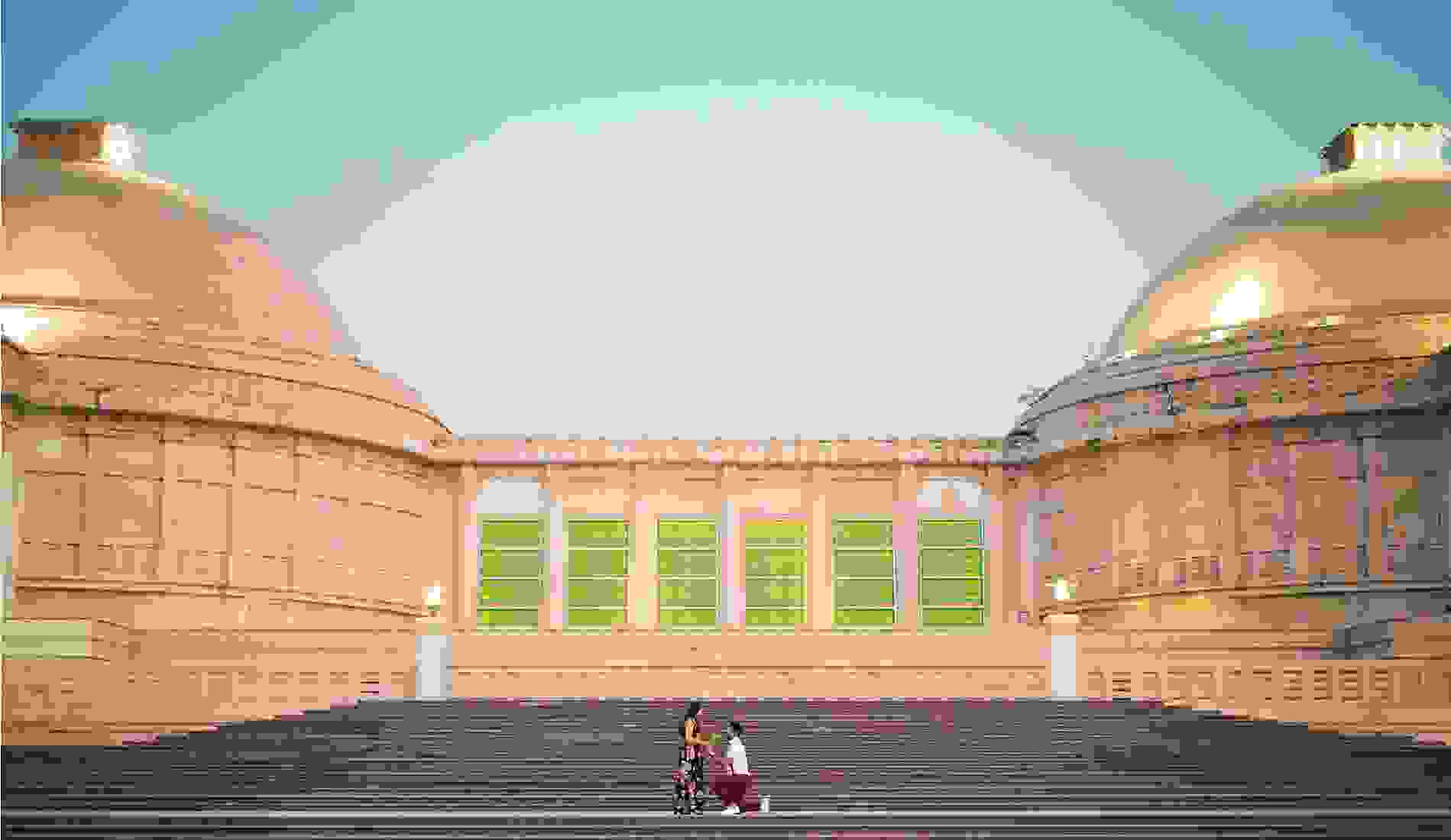 Man proposing to a woman on the steps of a grand architectural building with domed rooftops and vibrant green windows, during twilight. 