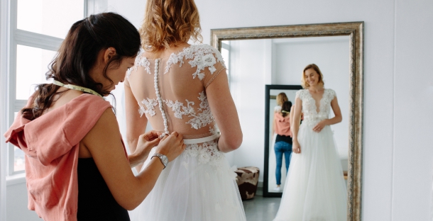 Bride trying on wedding dresses