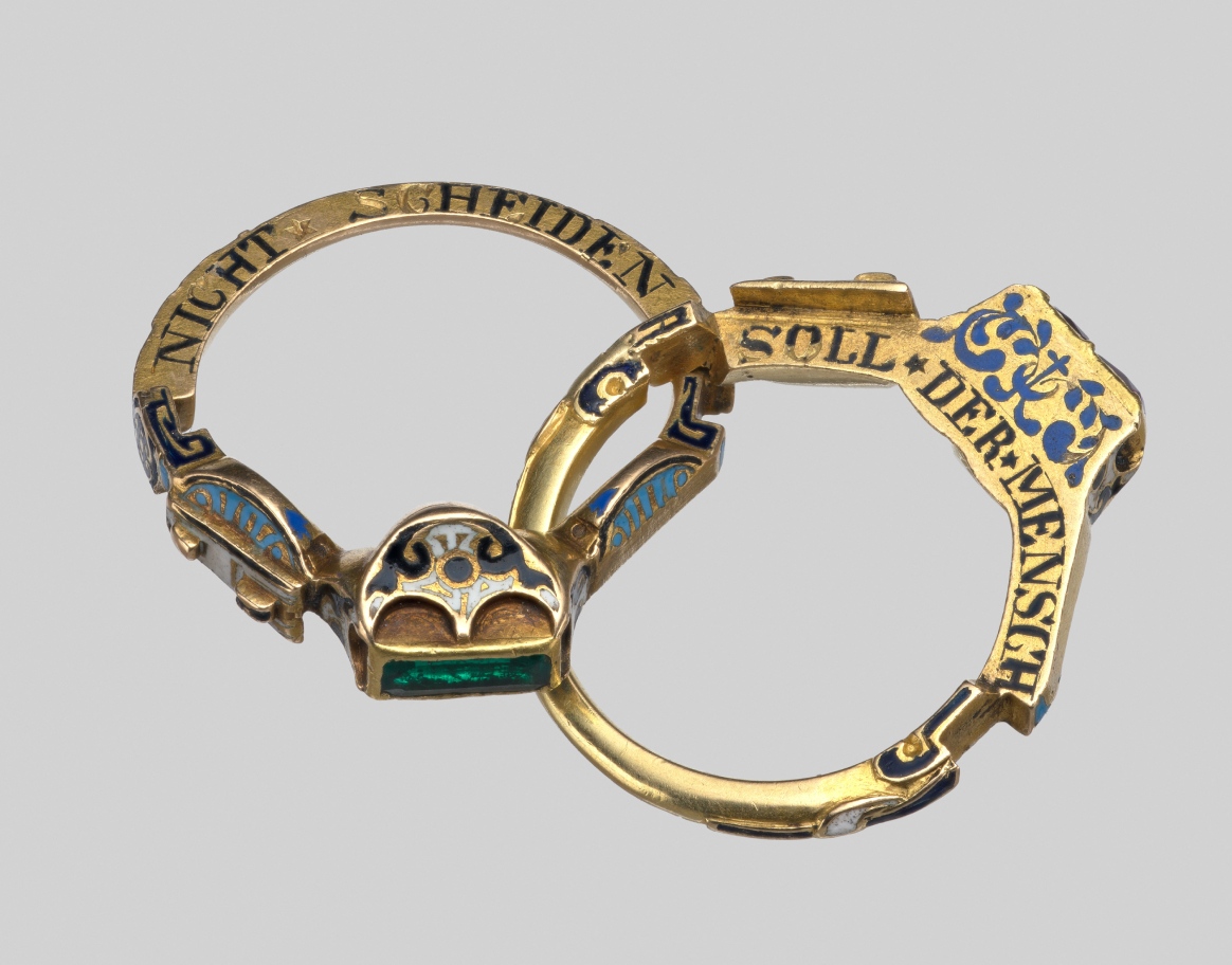 Stonecutter faceting red garnet stone on the metal dop stick into the round stone shape