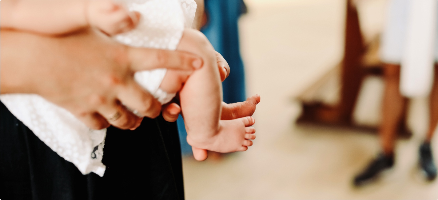 A baby being carried at a wedding