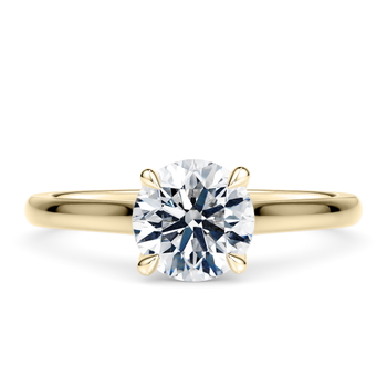 Amara in Oro Amarillo set with a Redondo cut diamante.
