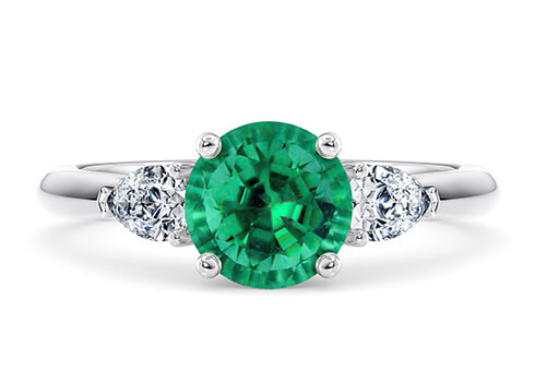 Florence in White Gold set with a Round cut Emerald.