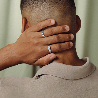 Man wearing two white gold wedding rings