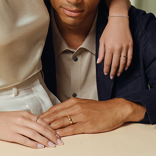 Couple wearing yellow gold and rose gold wedding rings